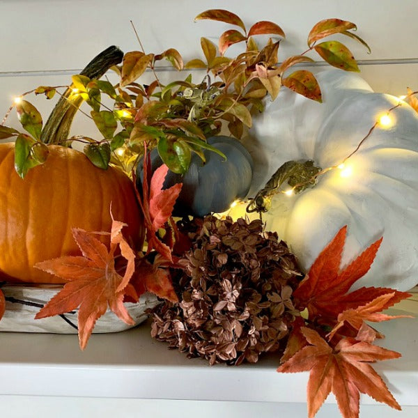 Fall Mantel with Persimmons and Pumpkins