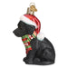 The Holiday Black Labrador Puppy Old World Christmas Ornament 12638 is a charming addition to your tree, showcasing a Black Labrador Puppy adorned in a red and white Santa hat with a festive red and green snowflake-patterned scarf. This delightful piece from Old World Christmas hangs elegantly with its loop and small golden tag.