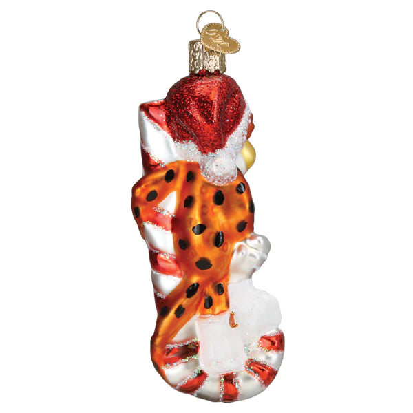 The Chester Cheetah on Candy Cane Ornament by Old World Christmas, model number 12660, features a whimsical cheetah resembling Chester Cheetah climbing into a peppermint-striped stocking, wearing a Santa hat and sprinkled with glitter to embody the playful spirit of the holiday season.