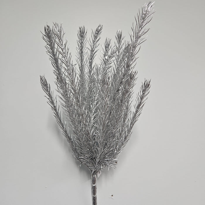 A detailed view of a 16" Silver Christmas Salix 83552-SIL branch showcases its numerous slender, spiky offshoots against a simple white background. The branch's shiny, reflective surface enhances its festive and decorative appeal.