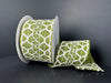 The 2.5X10Y Ivory Burlap Moss Scallop Linen Ribbon showcases a green hue with a white geometric pattern reminiscent of a net, partially unrolled against a dark background.