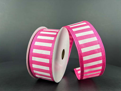 Two reels of 1.5X10Y Fuchsia Satin-White Stripes/Fuchsia Edge Ribbon 46425-09-28 stand upright against a dark background. One reel unwinds in loops, the satin stripes gleaming softly, while neatly stitched edges complete the look.