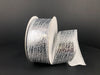 A roll of 1.5"X10Y Silver Crackle Lame Ribbon 75206-09-16 with a shimmering, textured pattern is showcased on a black surface. The wired ribbon is partially unrolled, highlighting its shiny, intricate design.