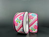 The two spools of 1.5"X10Y White Linen/Christmas Candy-Fuchsia-White Diagonal Stripe-Fuchsia Metallic Edge Ribbon present vibrant peppermint candy designs. Enhanced with a fuchsia metallic edge, these ribbons are set against a dark background to create a striking contrast.