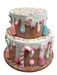 An 8" by 9" Blue and Pink Two Tier Cake (85788BLPK), decorated with white icing drips, vibrant sprinkles, and a stunning mix of pastel-hued candies such as lollipops and candy canes.