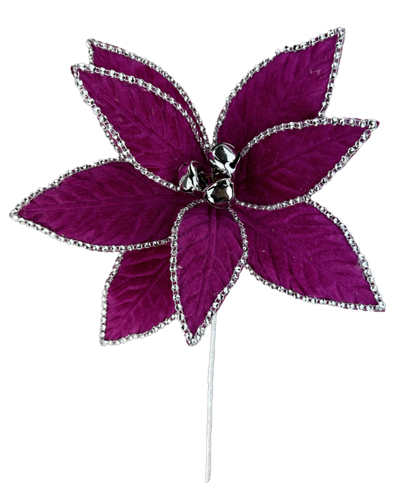 A 20" by 10" Hot Pink Rhinestone Velvet Poinsettia Stem 86103BT in shimmering magenta features glittery silver edging on each petal and is detailed with small silver bells at the center, set against a pristine white background.