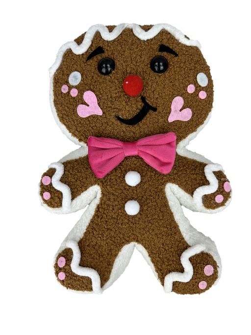 The 12" by 8" by 2" Pink Plush Gingerbread with Bow (product number 86132PK) features a cheerful gingerbread man design, complete with a smiling face, a red nose, and rosy blush marks. A pink bow tie adds a touch of elegance, while white icing details on its feet, hands, and head enhance the toy's sweet charm.