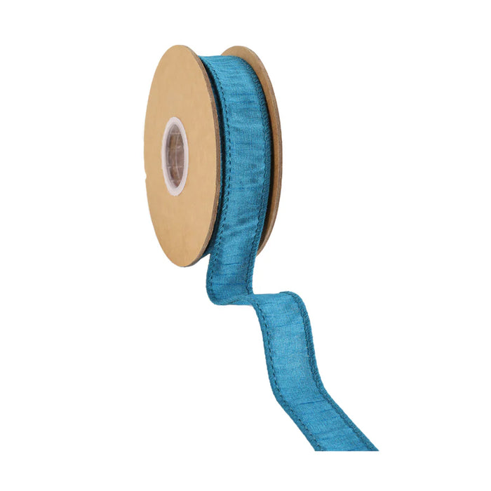 A spool of 1" Peacock Dupioni Wired Ribbon, item number 9100W-360-25E, with a brown cardboard core. The ribbon is partially unwound, showcasing its textured surface and neat edges, offering 10 yards of elegance.