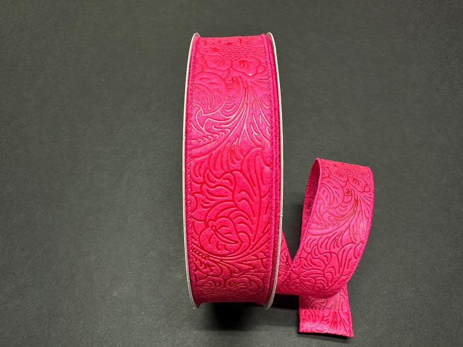 A roll of 1.5X10Y Fuchsia Flower Embossed Ribbon, featuring a floral pattern against a dark background.