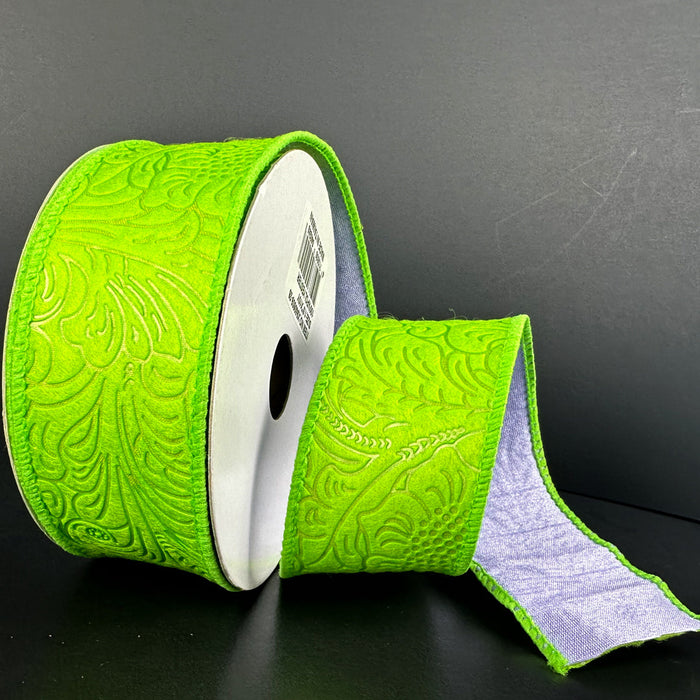 A large roll of the 1.5X10Y Lime Lavender Double Sided Embossed Dupioni Ribbon lies on a black surface. A section is unrolled, revealing its white underside, making this exquisite wired ribbon perfect for adding a refined touch to any project.