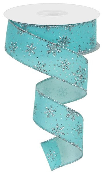 A roll of the 1.5" X 10Yd Ice Blue/Silver Glitter Snowflakes On Velvet ribbon (RGE1137RM), partially unwound and coiled in a spiral, is set against a plain white background.