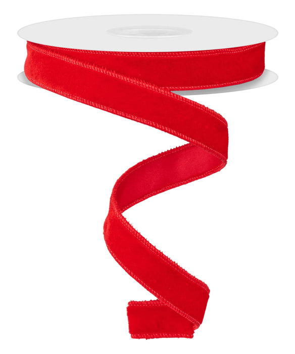 A spool of 7/8"X10YD Red Deluxe Velvet With Satin Backing Ribbon (RGE765824) unfurls gracefully in a spiral shape, showcasing its elegant satin backing for an added touch of luxury.