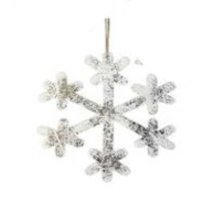 A 9" MDF Snowflake Ornament (MTX70852) in glittery silver with six branches, hanging against a plain white background. This ornament showcases assorted styles and intricate patterns, enhancing its sparkling appearance.