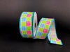 A spool of 1.5"X10Y Blue-Pink-Green Plaid Print Linen Ribbon (product code 41327-09-45) showcases a colorful checkered pattern featuring pink, blue, and green against a black background. Part of the wired ribbon is unrolled and elegantly displayed beside the spool.