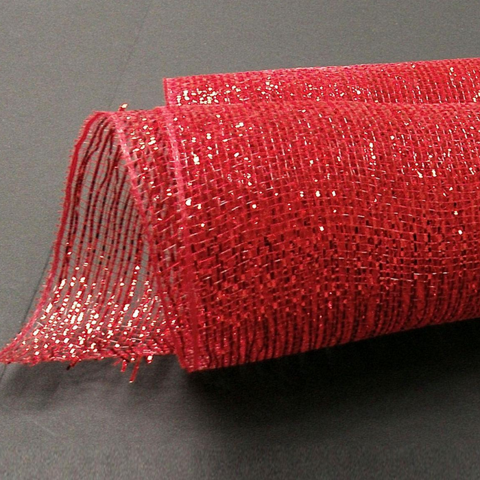 The 10" Red Metallic All Foil Mesh XB94210-12 is partially unrolled on a dark surface, featuring a glittery texture and an open weave that catches the light, creating a sparkling effect.