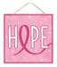 The 10" square Hope Sign (Product Code: AP8878) features a light pink background with a rope hanger and the word "Hope" in bold letters. The letter "O" is artistically represented as a hot pink ribbon to symbolize breast cancer awareness, while white dots are sprinkled across the background for an added touch of whimsy.