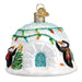 The Igloo 20110 Old World Christmas Ornament captures the holiday spirit with colorful string lights. It features two scarf-clad penguins decorating a small Christmas tree next to the igloo, and its entrance is accented with glitter, making this hand-painted glass piece a delightful addition to your décor.