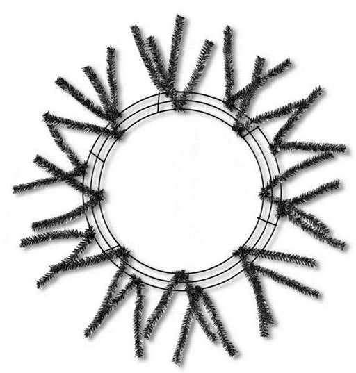 The 24 Pencil Work Wreath Metallic Black XX751102 features sparse, spiky branches in a circular design on three concentric metal rings, offering a minimalist starburst look against a white background.