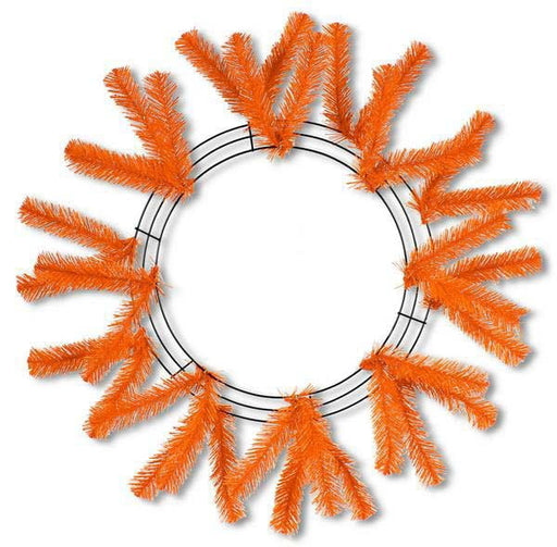 The 24 Work Wreath Orange XX748820 features vibrant artificial pine-like branches, offering a textured look suitable for holiday creations, with an empty center that reveals the white background.